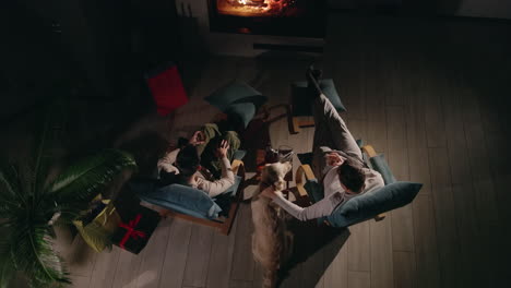couple relaxing by the fireplace with a dog