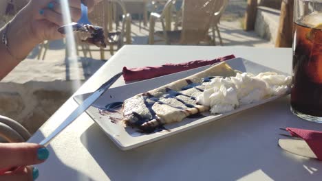 Woman's-hands-cutting-a-crepe-with-syrup-in