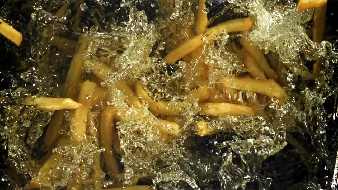 Golden French Fries Deep Frying in Bubbling Hot Oil