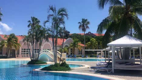 swimming pool and palms in caribbean resort, varadero, cuba in summer, panning shot