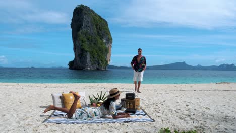 koh poda beach krabi thailand, a couple of asian women and european men walking on the tropical beach of koh poda.thailand