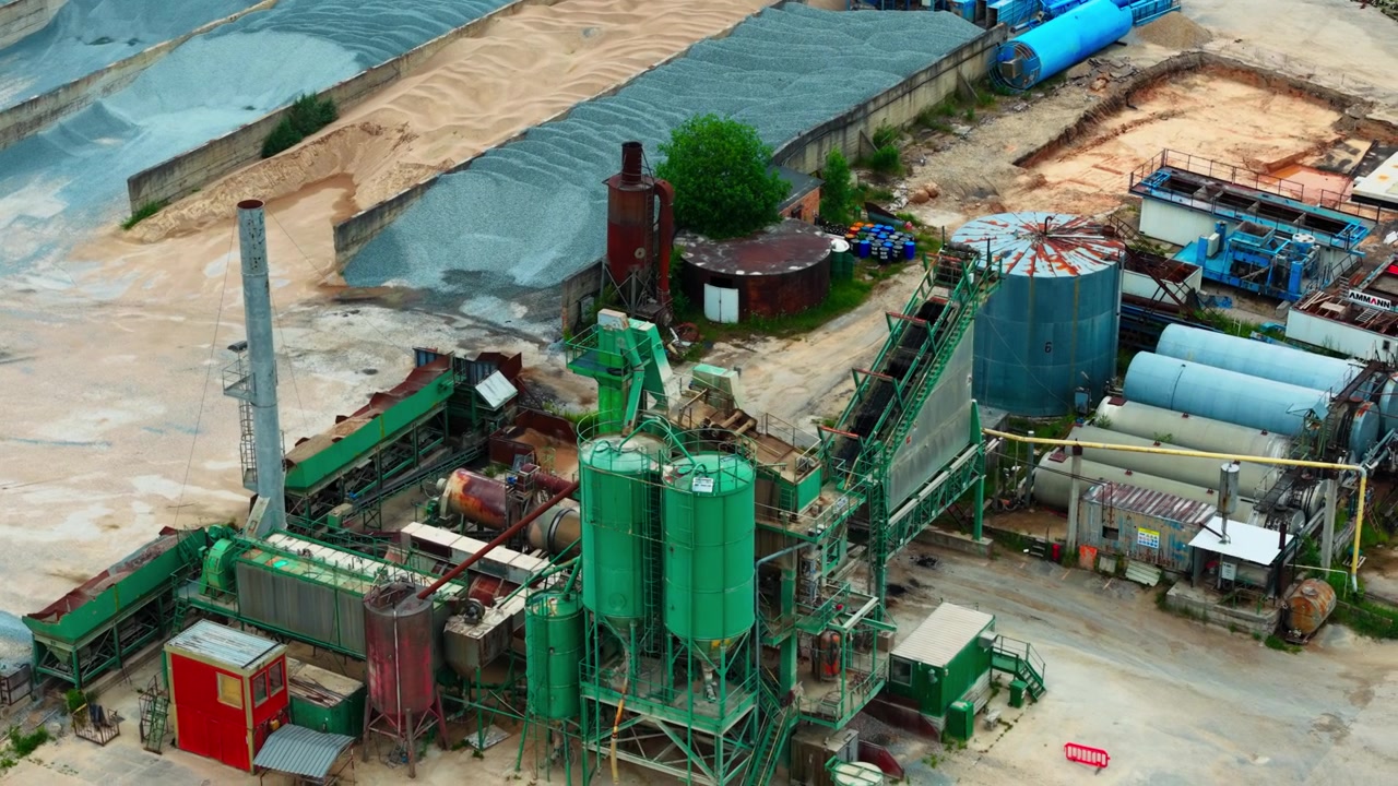 Drone view, asphalt production equipment silos conveyors and mineral stockpiles