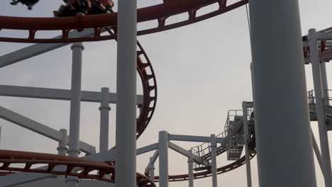 slow motion: roller coaster train slowly passing over the circuit in dream world, thailand