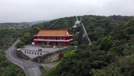 aerial forward shot of asian dog temple with parking cars in taiwan