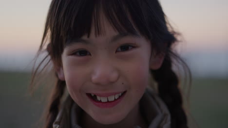 close up portrait of cute asian girl smiling cheerful enjoying happy summer vacation on seaside park