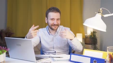 home office worker man dances looking at camera.