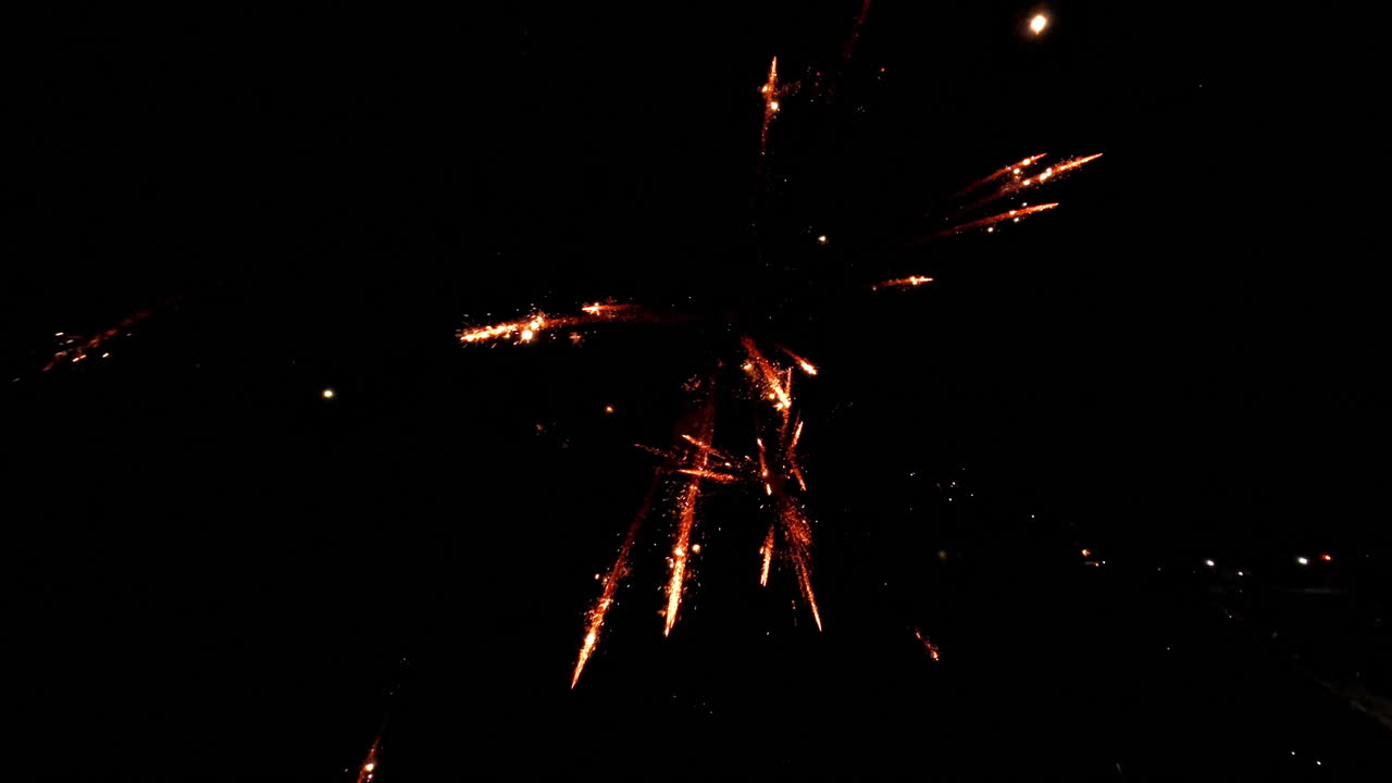 Explosive fireworks burst in dark sky, creating dazzling spectacle