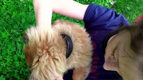 child kissing her puppy, child playing with her little dog