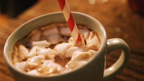 cup of coffee with straw on a table