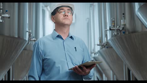 engineer monitoring production in a brewery