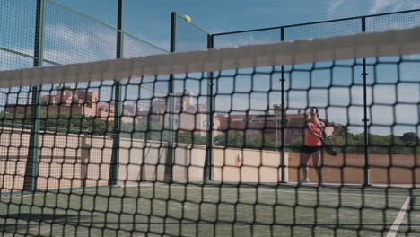 padel tennis player does a drive shot