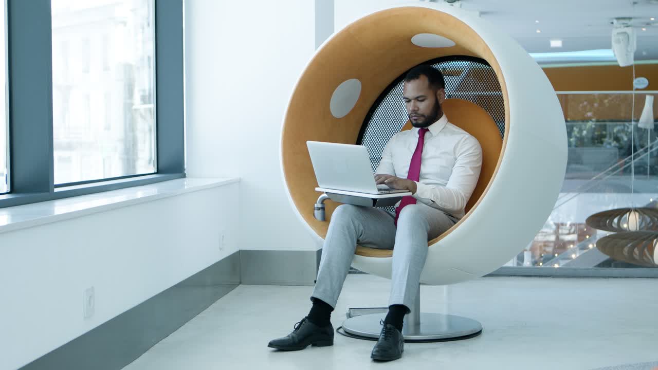Serious businessman using laptop