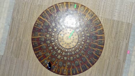 People walk past admiring mini dome with ancient inscriptions in Weihai, China, bird&#039;s eye view