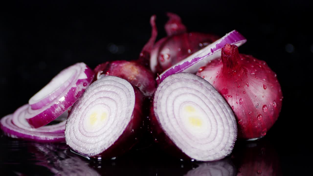 Slices of red onion are in the water.
