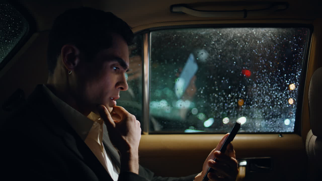 Car passenger reading phone screen luxury salon close up. Business man working