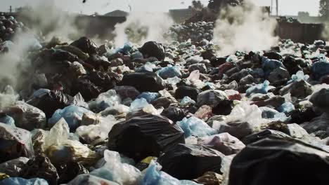 a haunting visual of environmental decay: mountains of trash accumulate and fester under heavy smoke, signifying the urgency for waste management and environmental awareness