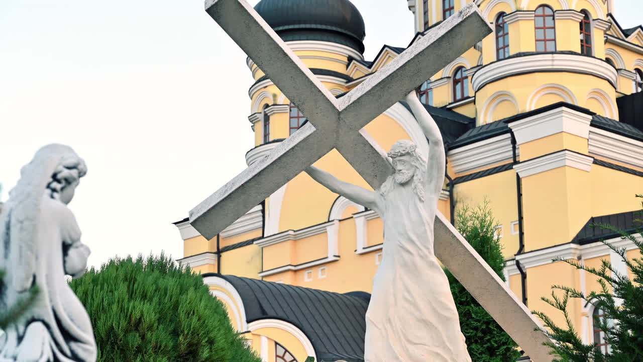 Stunning sculptures stand in front of a grand building as the sun sets. The peaceful atmosphere highlights the craftsmanship of the art and architecture around