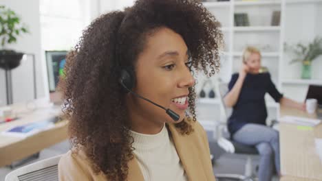 woman talking at a customer with headphone