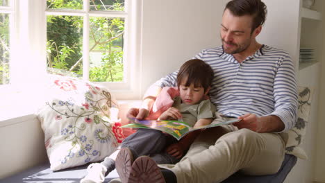 father and son reading story at home shot on r3d