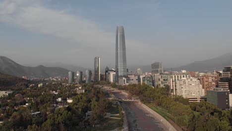 Descending-aerial:-Gran-Torre-Santiago-and-bridges-over-Rio-Mapocho