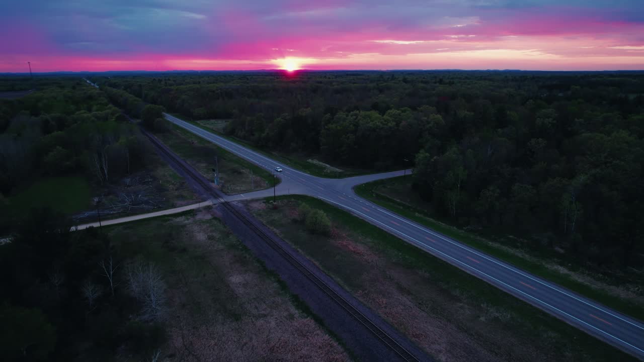 Aerial View of Marshfield Wisconsin Road and Railroad Intersection at Sunset with Glowing Sky