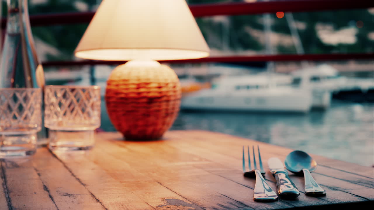Close up view of a lamp on a set table at a restaurant near a port in the south of France