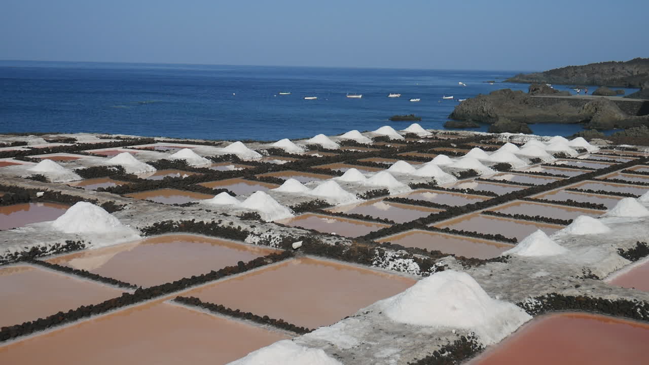 Panning shot over the Fuencaliente salt flats on the Canary Island of La Palma by the Atlantic Ocean