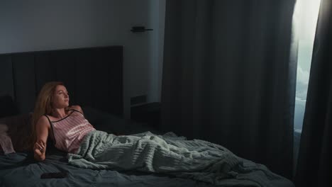 woman waking up in bedroom