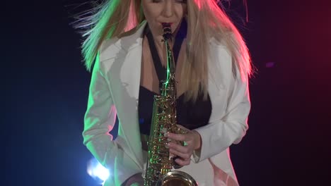 woman playing saxophone on stage
