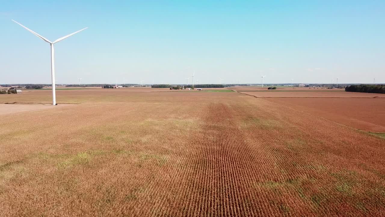 Aerial over a wind turbine producing alternative electricity in rural Michigan
