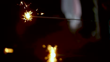 slow motion shot of some people holding sparklers fireworks during a time of celebration