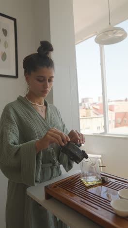 woman preparing tea in kitchen