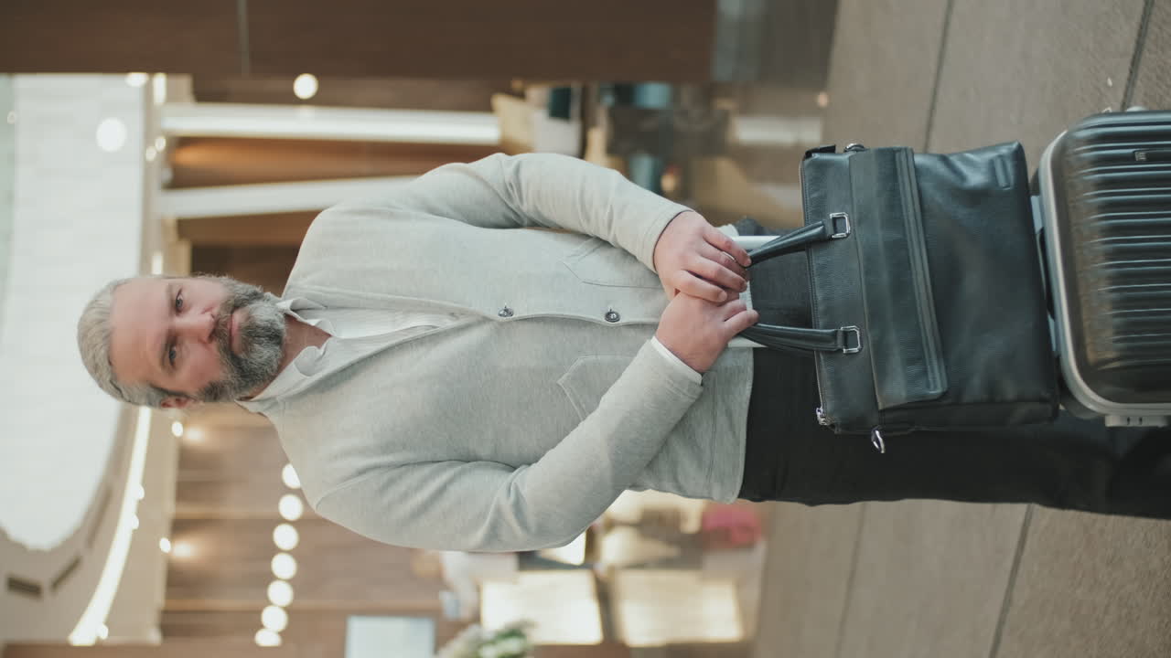 Portrait of Businessman with Luggage in Hotel