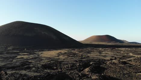 flying near two volcanos over the solid lava in lanzarote