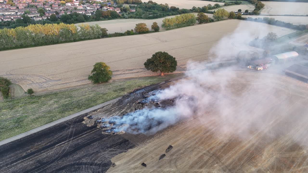 Clouds of smoke after Farm Field Fire Essex UK fire engine attending drone,aerial