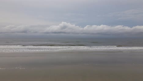 Deserted-beach-waves,-ilha-comprida,-são-paulo,-brazil,-aerial-drone-push-in