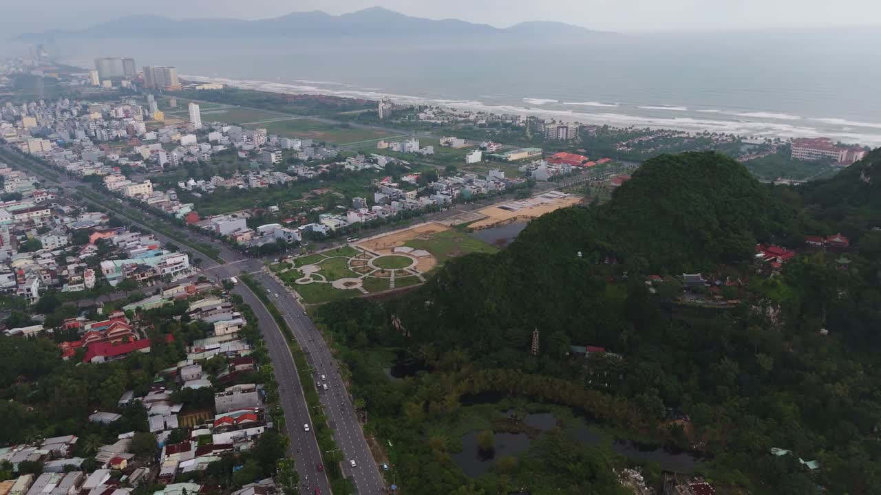aerial of Marble Mountain in Da Nang city in Vietnam Buddhist temples drone above ocean beach and cityscape
