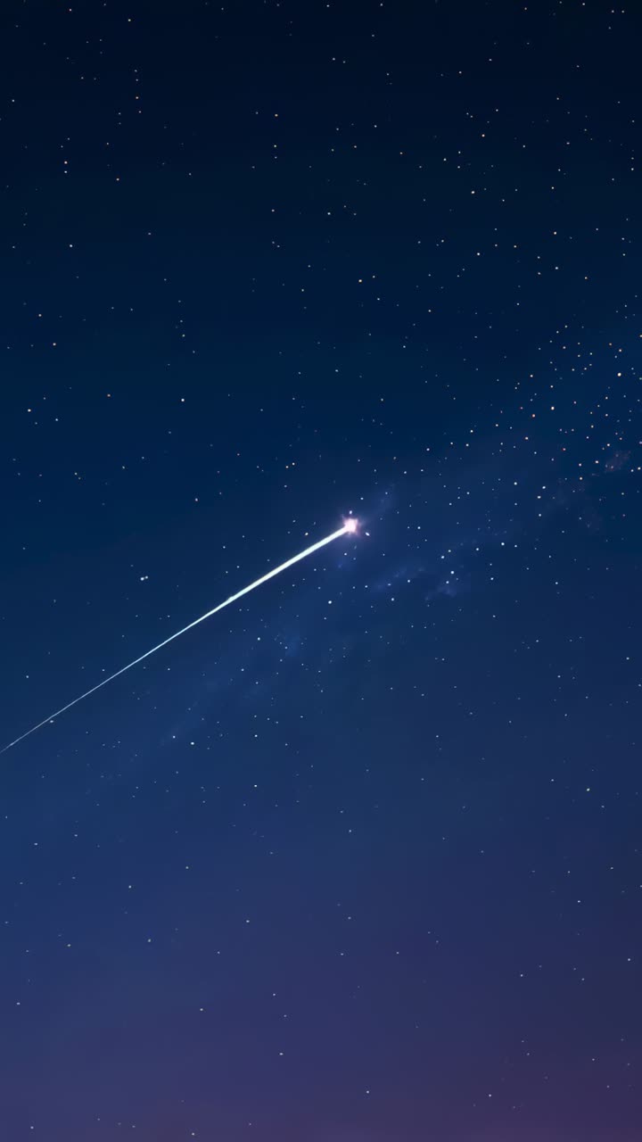 Vertical video: Entering atmosphere, bright meteor streaking across clear starry sky via Milky Way