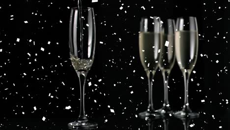 Animation-of-falling-confetti-over-champagne-filled-flute-glasses-against-black-background