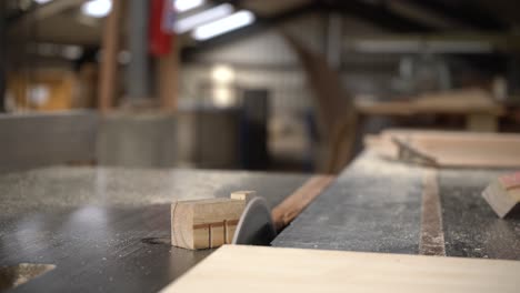 an electric saw is used to cut a block off of a wooden plank