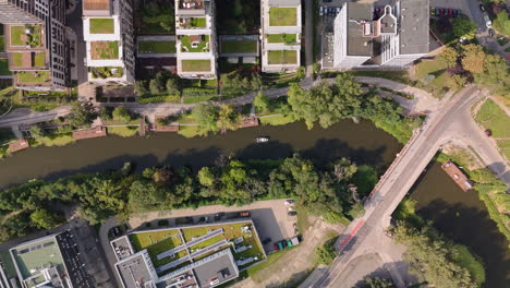 aerial view of a city with a canal and green spaces