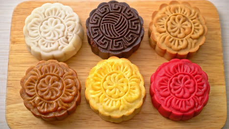 colourful chinese moon cake with mixed flavour on wood plate