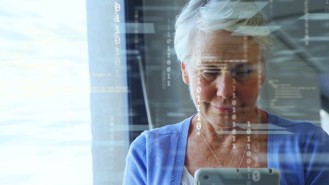 Senior woman tapping tablet by window, activating tech overlay viewing code streaks across scene