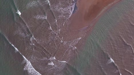 crystal-clear-water-of-philippine-ocean,-waves-gently-splashing-on-one-of-the-sandbars-in-surigao-philippines,-aerial-drone-rotating-overhead-shot