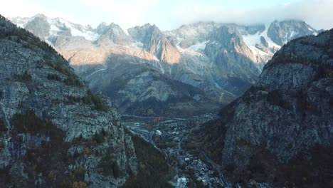 calm descending aerial at iconic mont blanc from courmayeur, italy, aosta valley, italian alps in autumn with fall colors on forest and trees