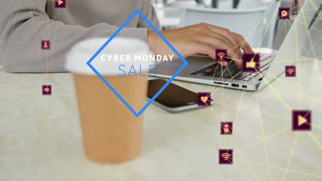 animación de texto de venta de cyber monday, iconos conectados, sección media de un hombre biracial trabajando en una computadora portátil.
