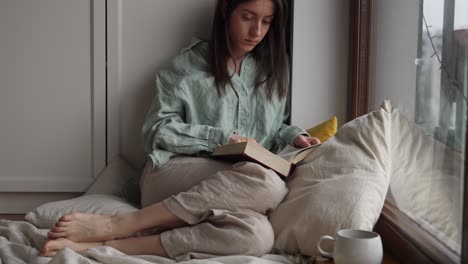 woman reading by the window