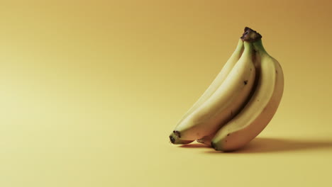 video of bananas with copy space over yellow background