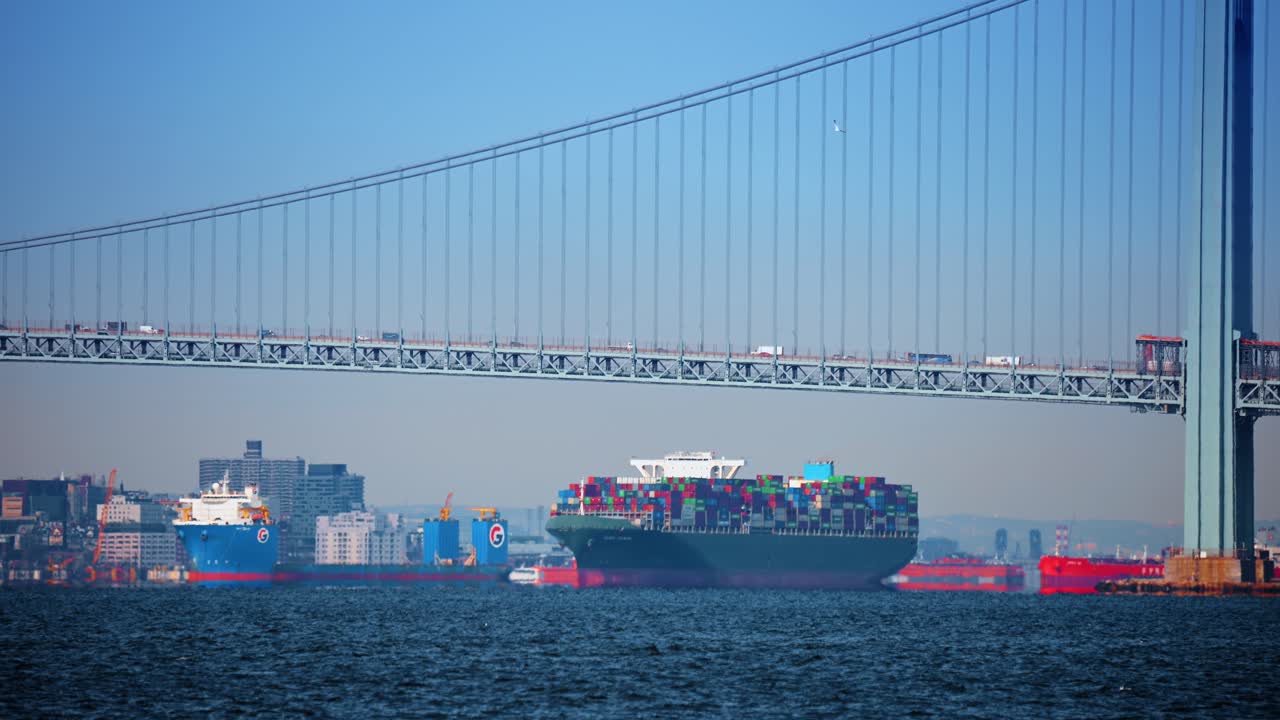 New York, USA, 24 December 2025: Container traffic near Verrazzano Bridge