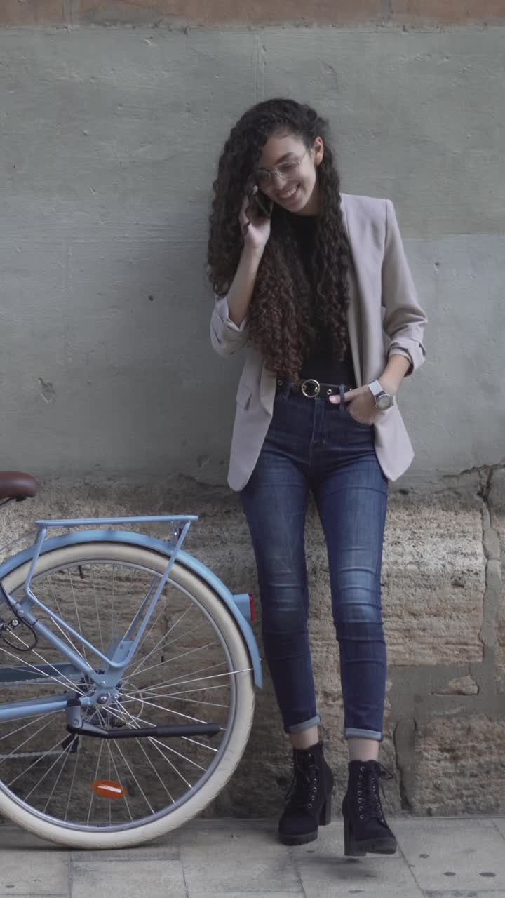 Woman talking on phone near a bicycle